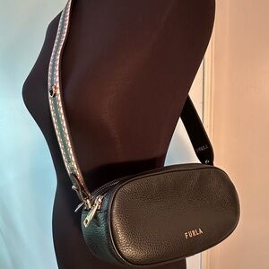 Furla Black Oval Crossbody Bag with Elegant Design and Reversible Strap